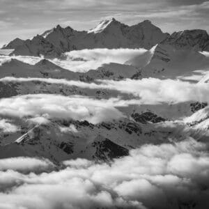 moutain image of Dom des Mischabels - Sea of ​​clouds over the mountain ranges of the peaks of the Valais Alps near Crans Montana