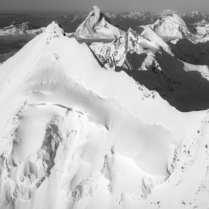 Black and white image of the snow capped mountain peaks of the Weisshorn North Ridge
