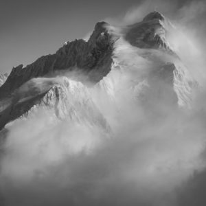 Jungfrau- black and white picture of Bernese alps pieak and mountain massif in a sea of clouds