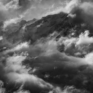 Black-and-white photo of Mont Vélan enveloped in storm clouds, Valais Alps, Entremont valley
